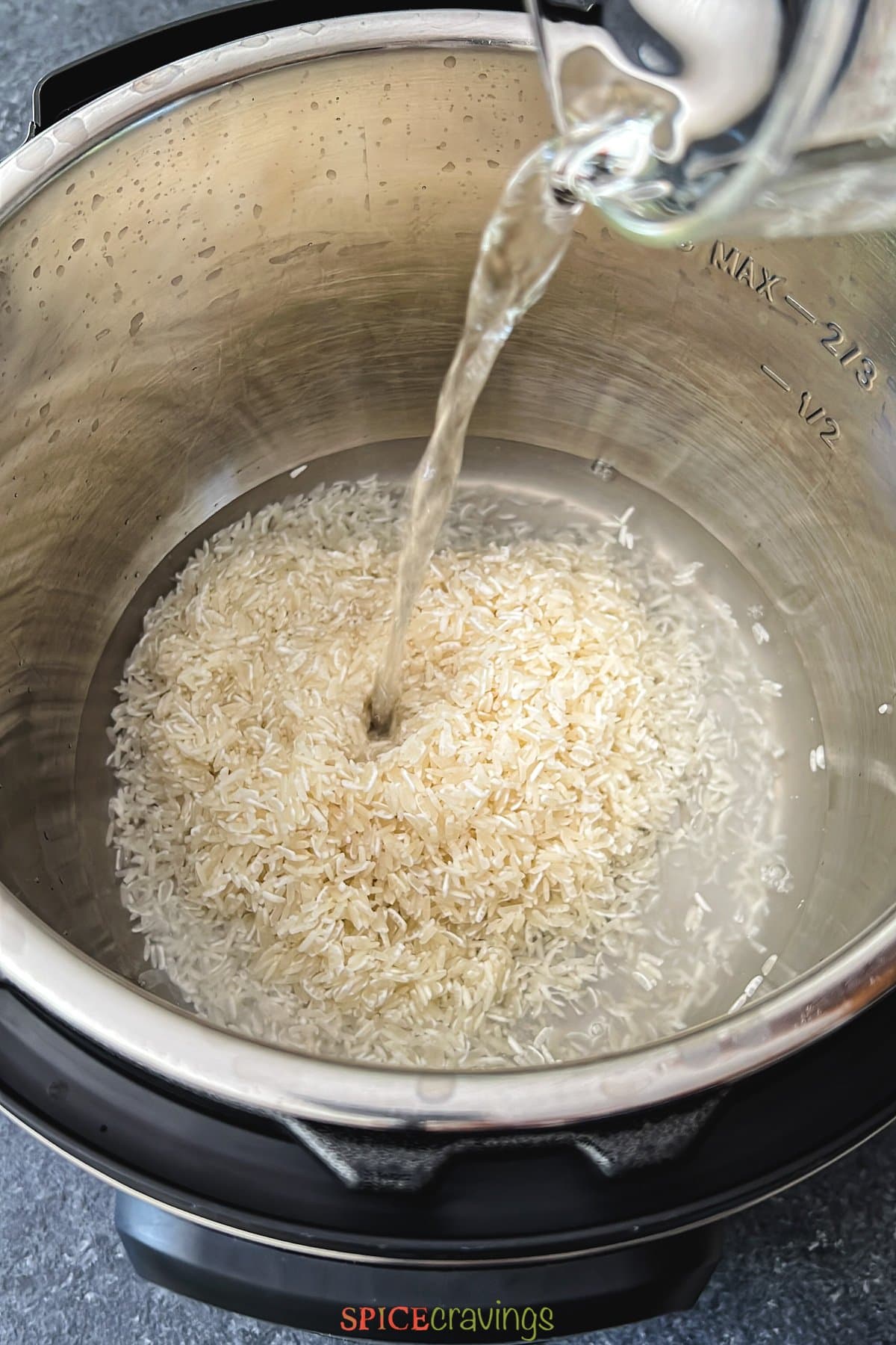 pouring water over jasmine rice in instant pot