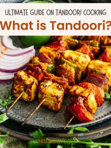 three tandoori meat and vegetable skewers on silver platter