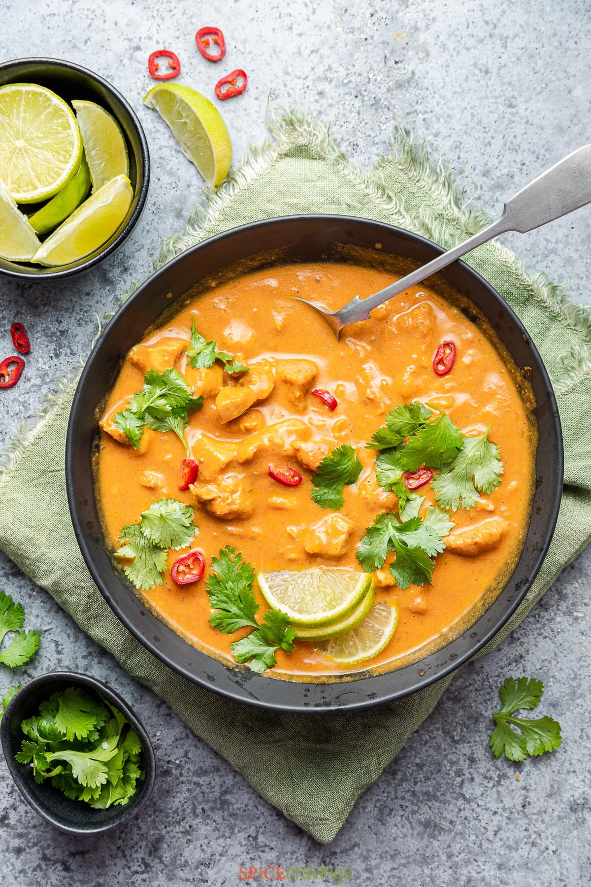 chicken coconut curry in black bowl with spoon