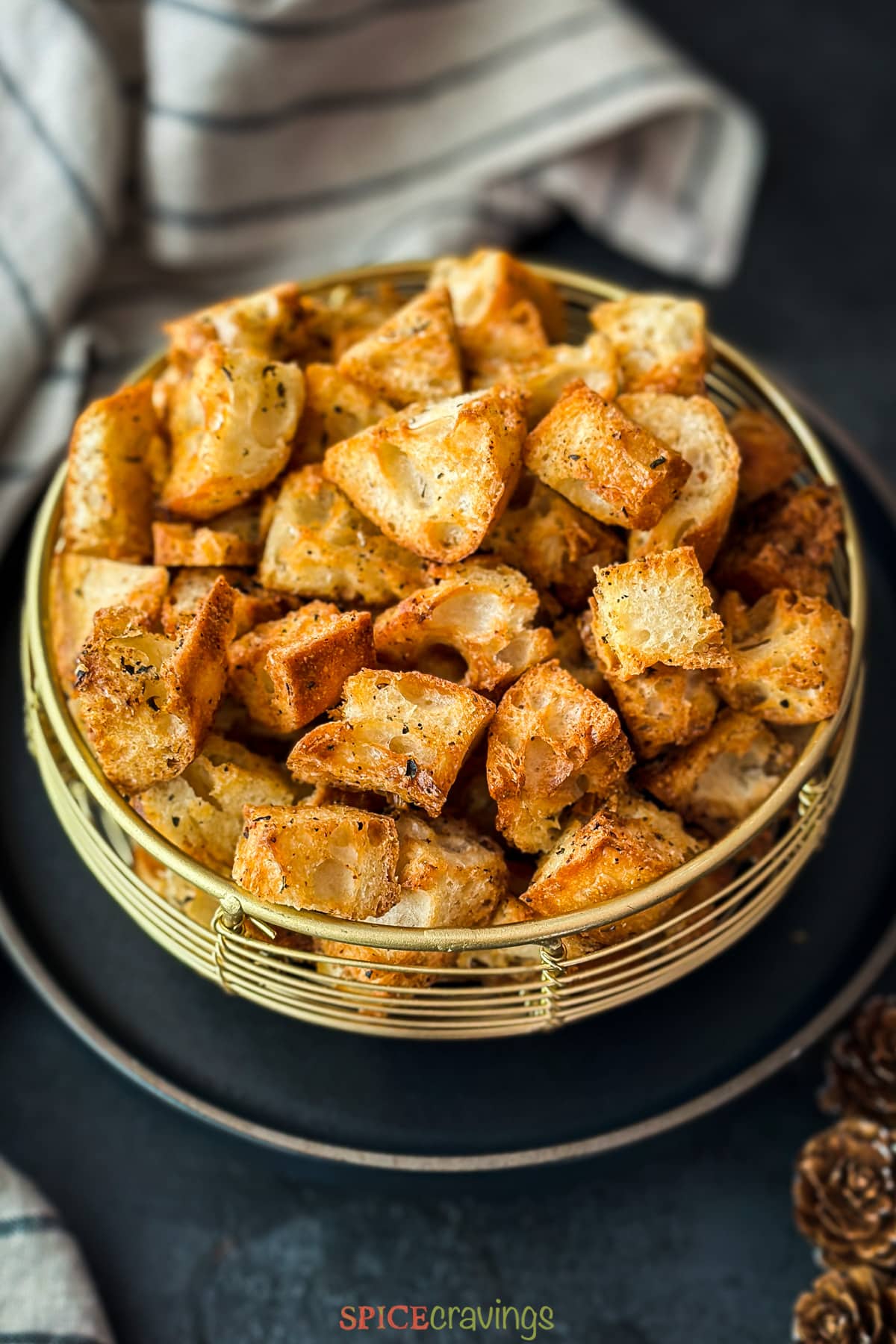 Side view of a croutons in a golden basket