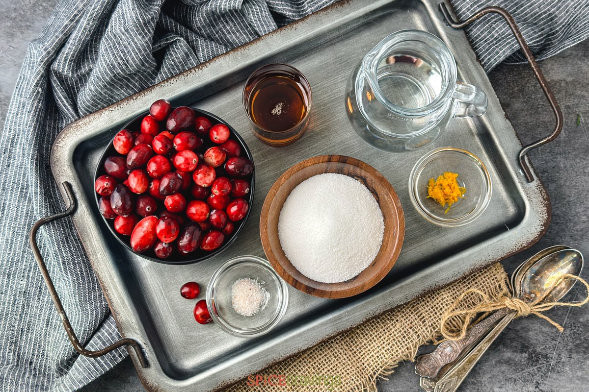 Cranberries, sugar, and water among other ingredients on metal tray