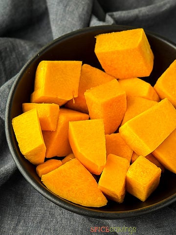 Black bowl with cubed butternut squash
