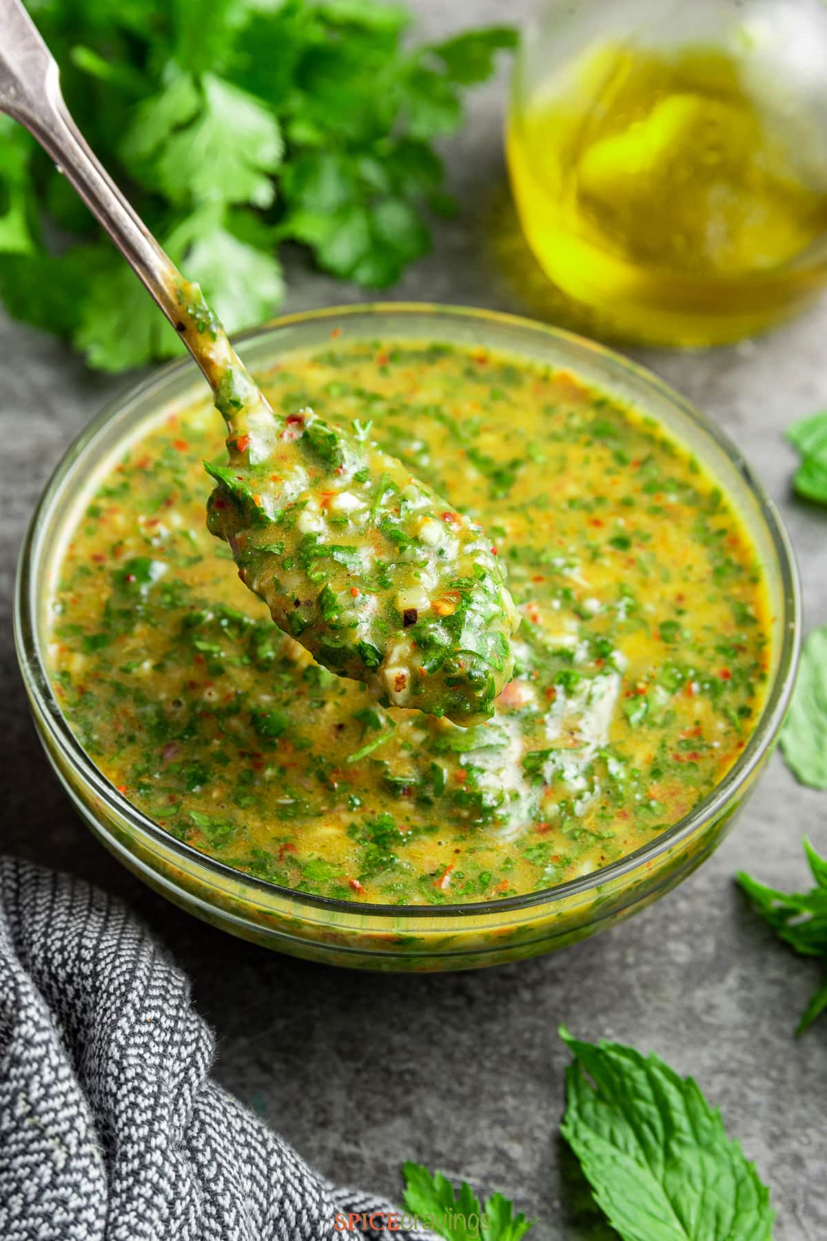 chimichurri cilantro sauce in glass bowl with spoon