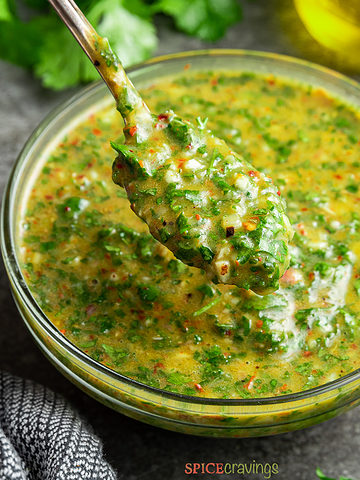 cilantro chimichurri sauce in glass bowl with spoon