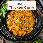 Creamy curry with chicken in black bowl
