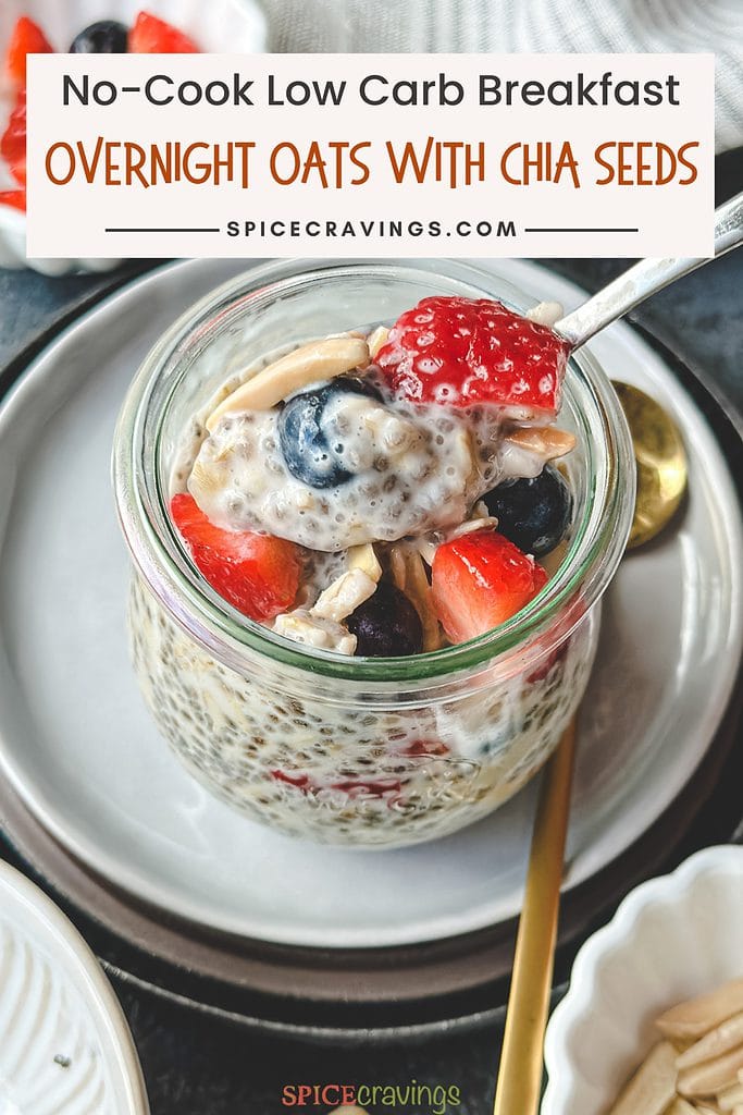spoon scooping chia seed overnight oats in glass jar topped with berries and nuts