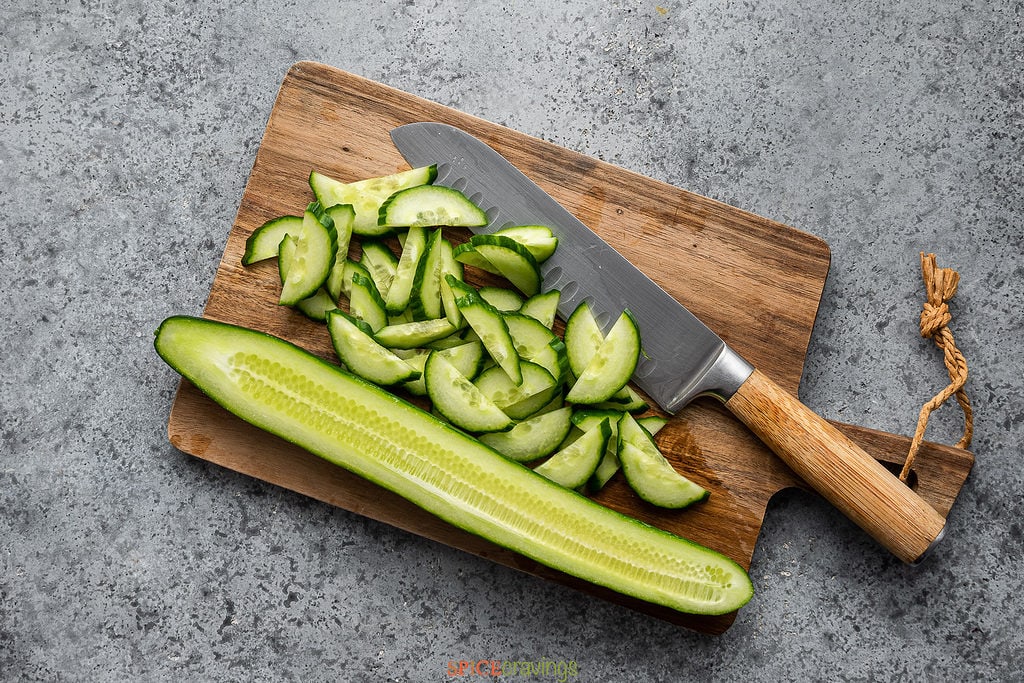 English cucumber sliced on wooden board