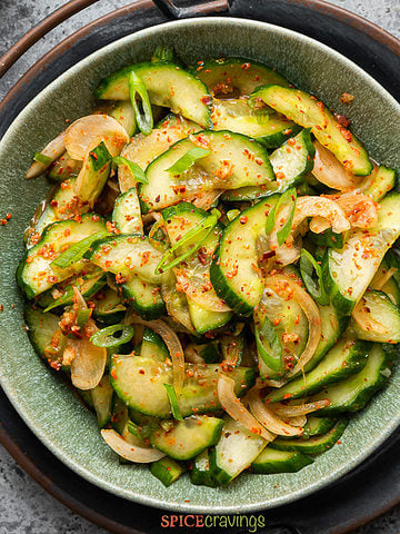 Slices of cucumber with green onion, seasoned with red pepper flakes