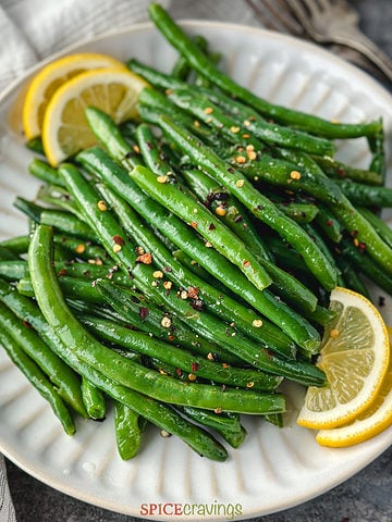 sauteed green beans in instant pot on white plate