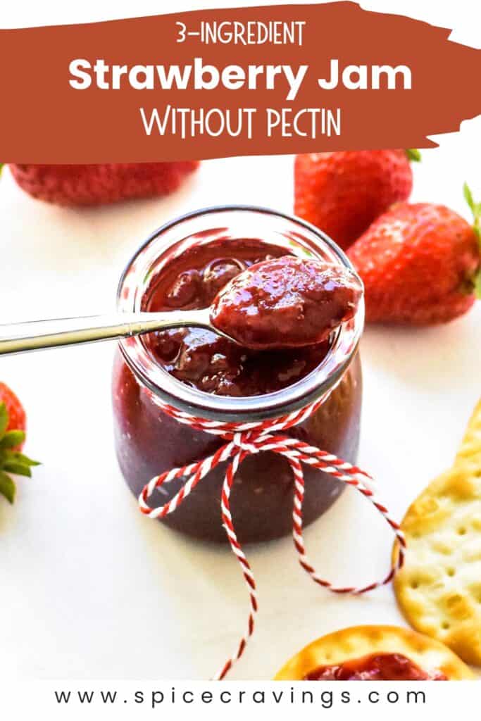 A spoon of strawberry jam placed over the jar of jam tied with red and white string