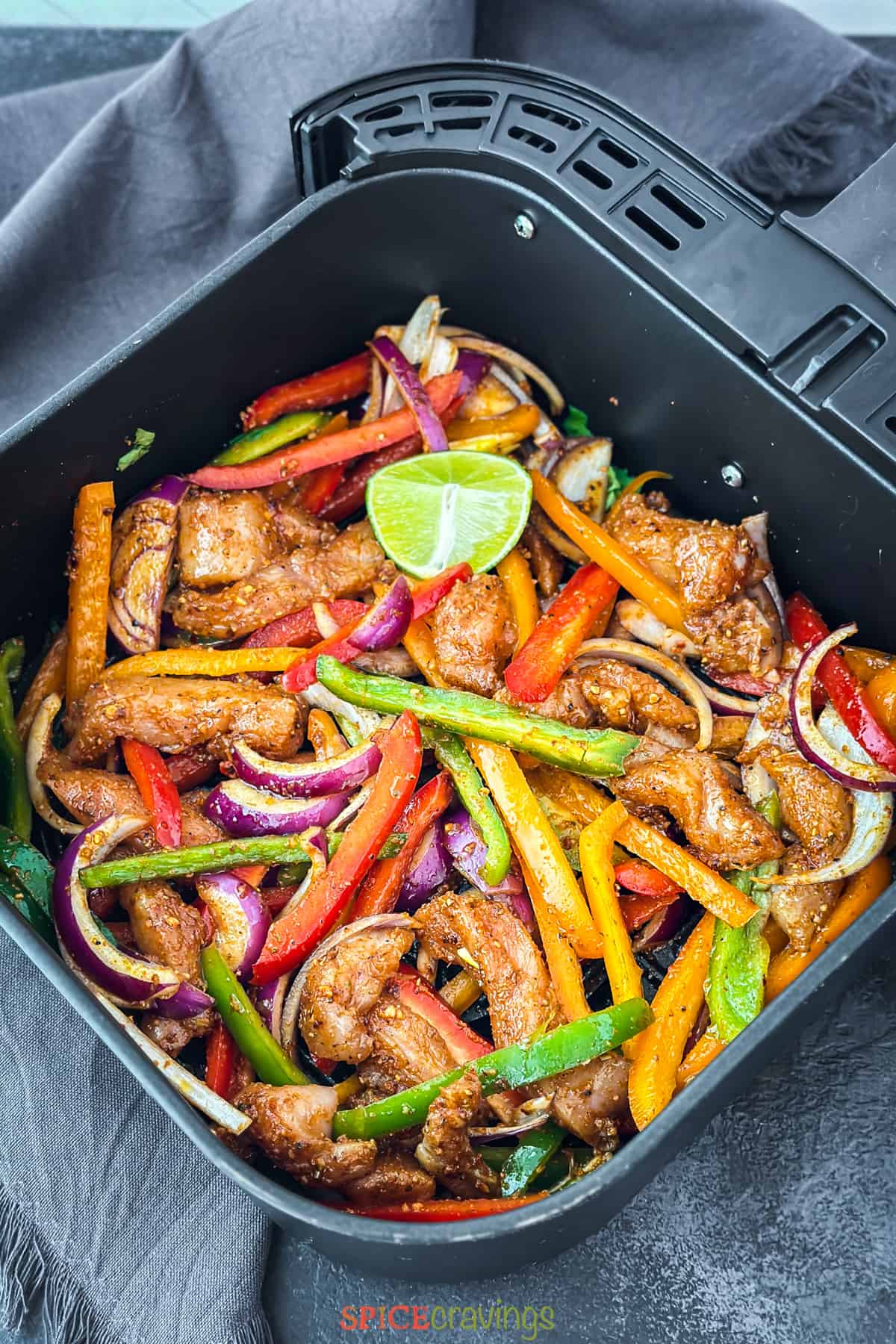 seasoned chicken, peppers and onions in air fryer basket