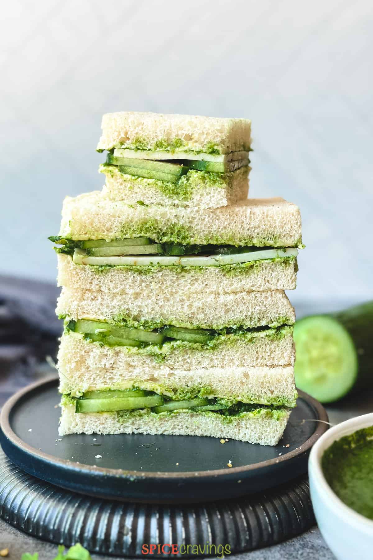 cucumber chutney sandwiches with cheese stacked on a plate