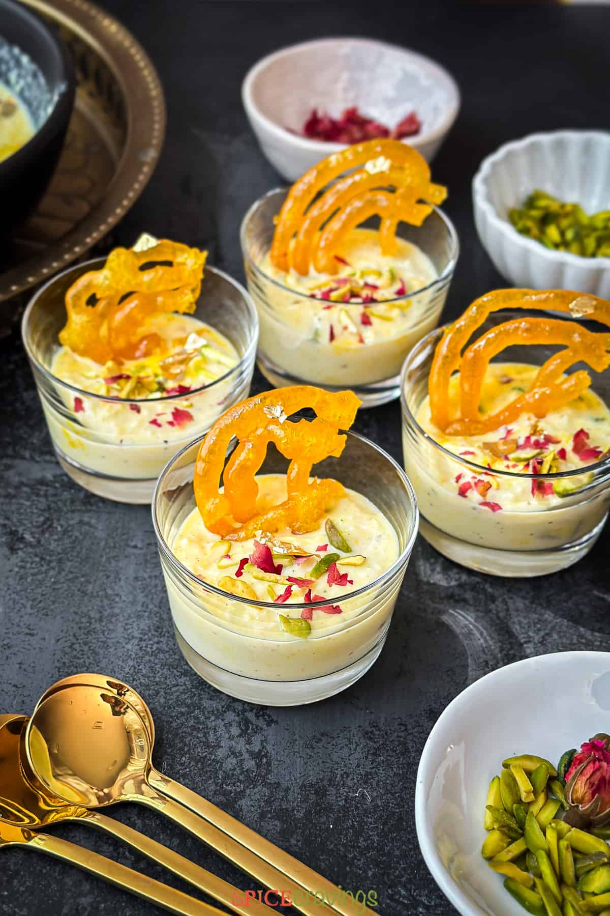 4 cups filled with rabdi, garnished with jalebi