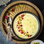 Close up of Indian sweetened milk pudding called rabdi, garnished with rose, pistachios and gold foil