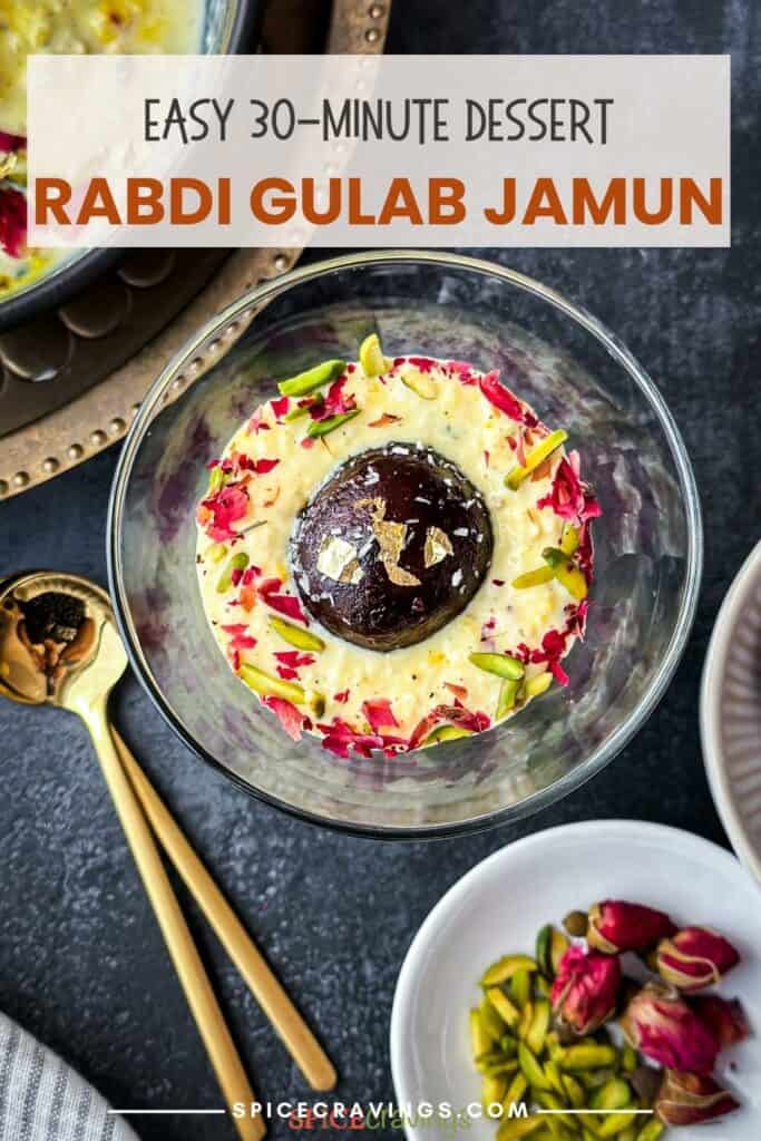 Rabdi in a cup topped with gulab jamun garnished with pistachios and rose petals