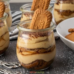 layered Biscoff tiramisu in small glass jar with speculoos cookie