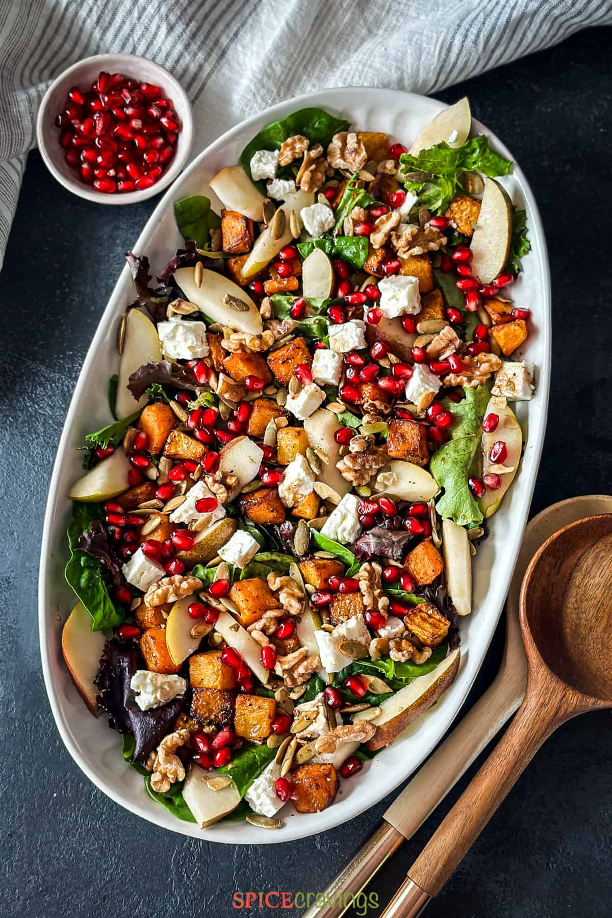 Salad platter with greens, butternut squash, feta and pomegranate