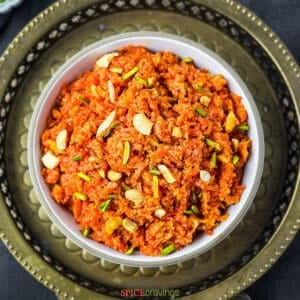 Top view of carrot halwa garnished with nuts
