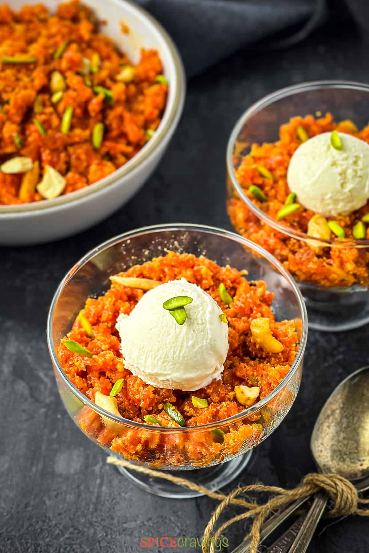 Carrot halwa toped with vanilla ice cream in glass cups