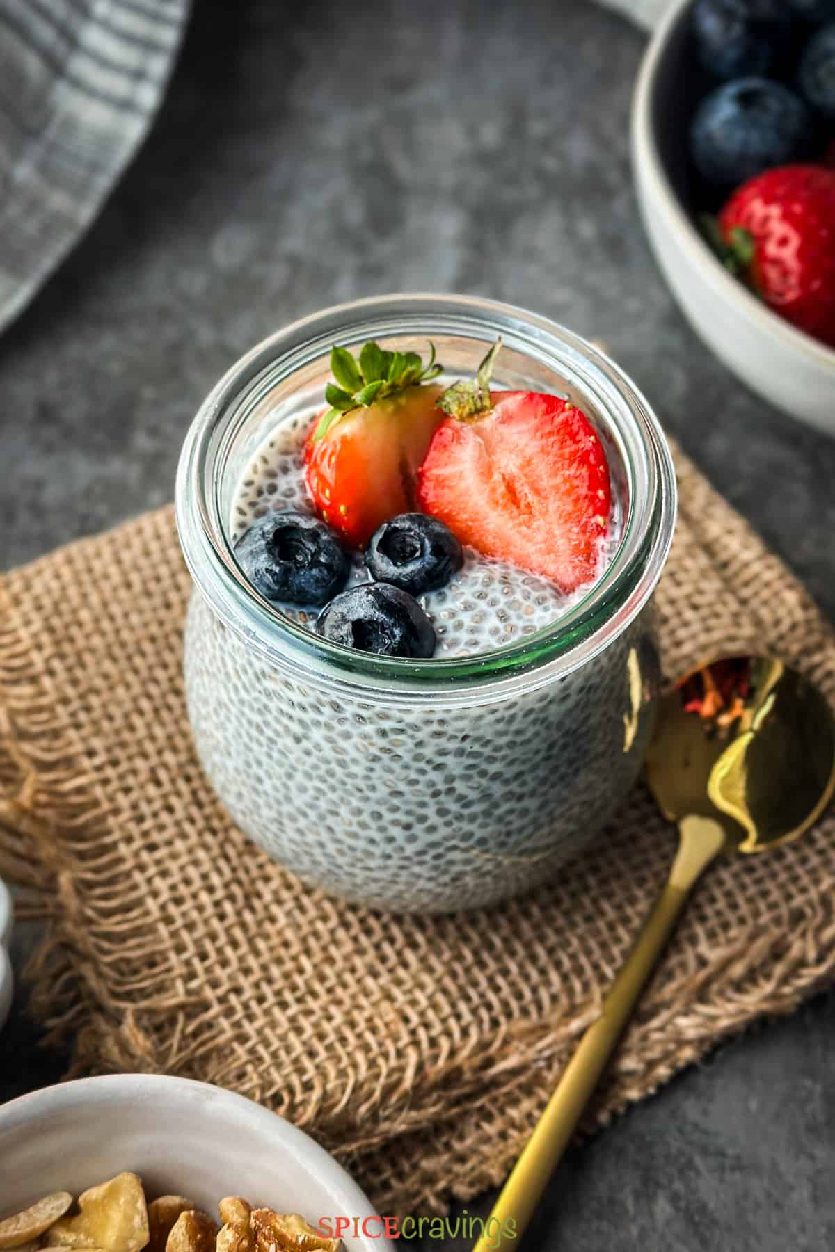 chia seed pudding in glass jar topped with fresh berries
