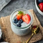 chia seed pudding in glass jar topped with fresh berries