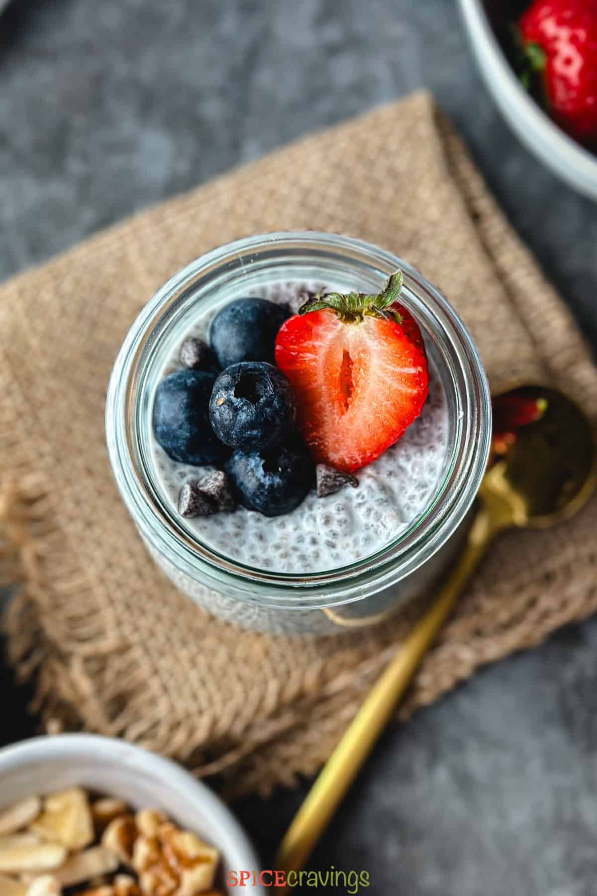 coconut milk chia pudding in glass jar topped with fresh berries