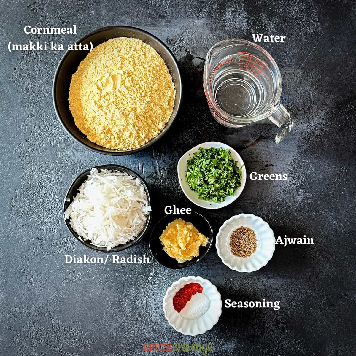 cornmeal, water, diakon, greens amond other ingredients on grey board