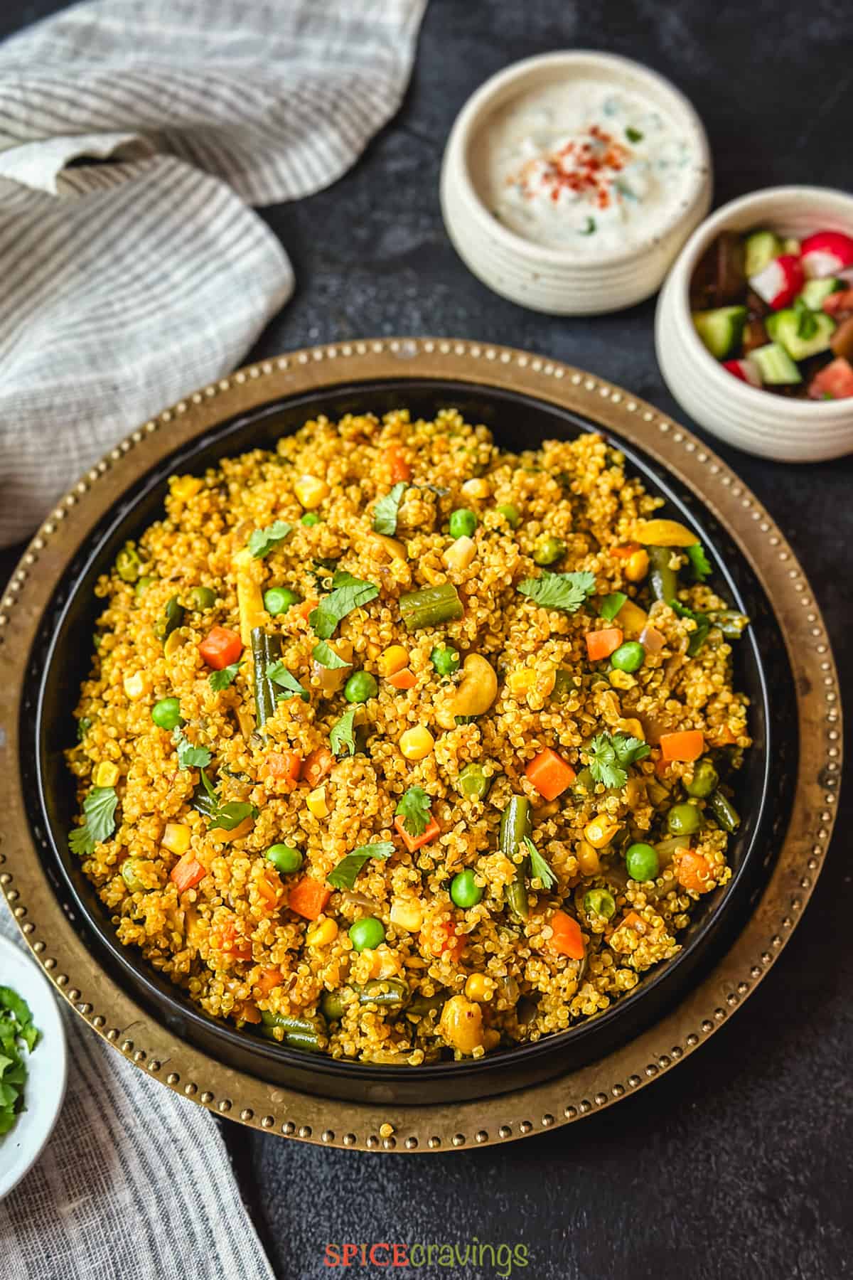 Quinoa and assorted vegetable pilaf in black plate