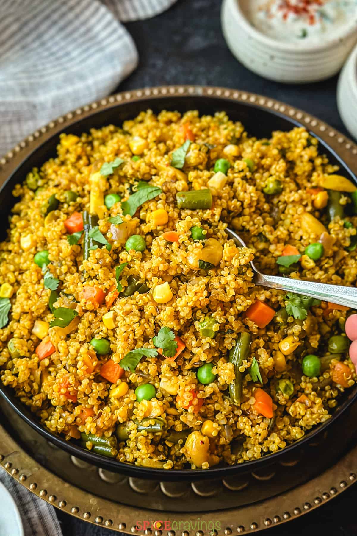 quinoa and vegetable pulao in black plate