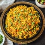 Quinoa and assorted vegetables pilaf in a black bowl