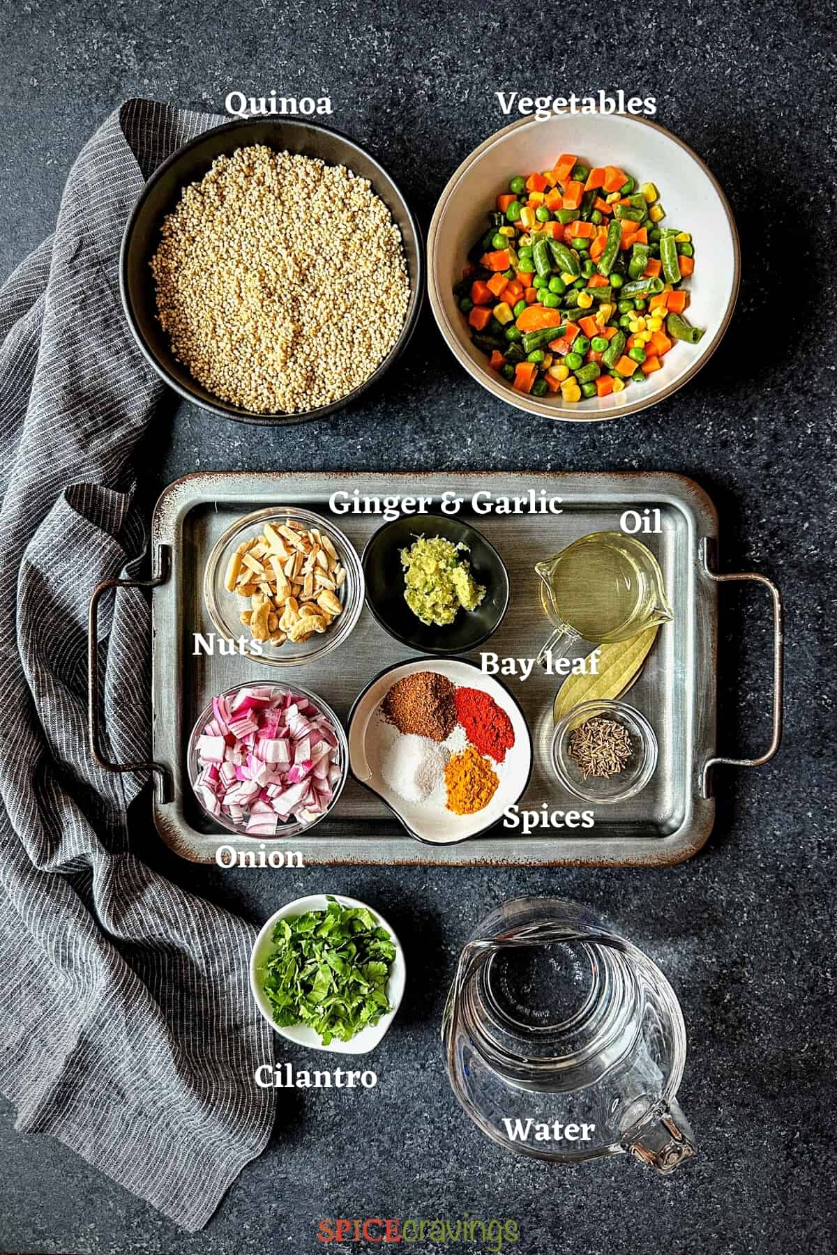 frozen vegetables, quinoa, water, nuts among other ingredients spread on a grey board