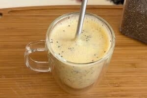 Stirring the chia seeds in a glass cup for a delicious 5-minute mango chia pudding with cardamom