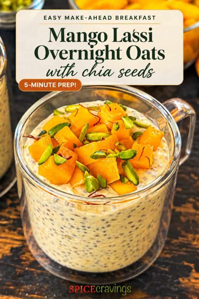 Mango Lassi Overnight Oats in a glass with chia seeds and mango chunks.