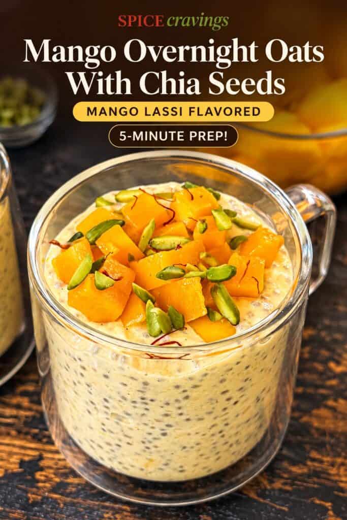 Mango overnight oats with chia seeds in a glass jar, topped with fresh mango and pistachios.