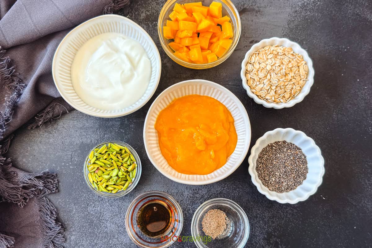 ingredients for making mango lassi overnight oats with chia seeds- yogurt, mango pulp, cardamom, saffron, pistachios