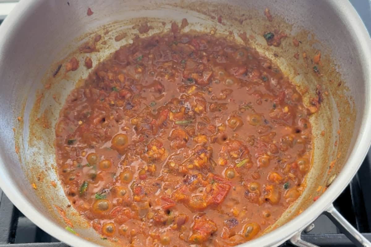 base curry ready in a pan for moong sprouts curry